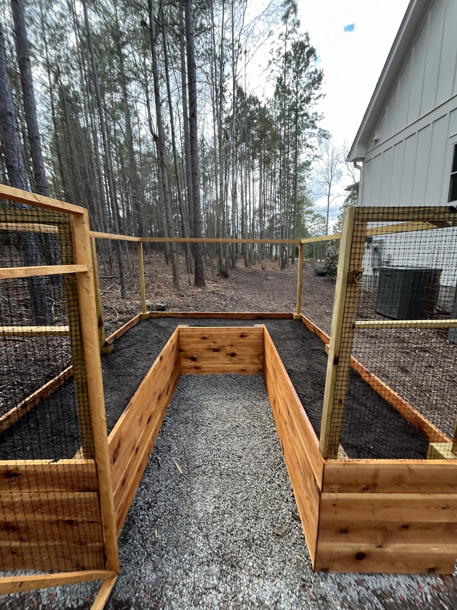 Fresh mulch beds and cleaned front landscape around a home.